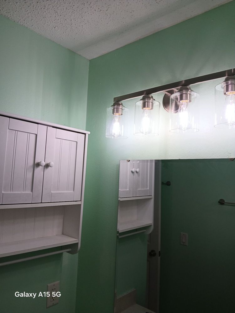 Bathroom — new vanity light bar installed, white storage cabinet